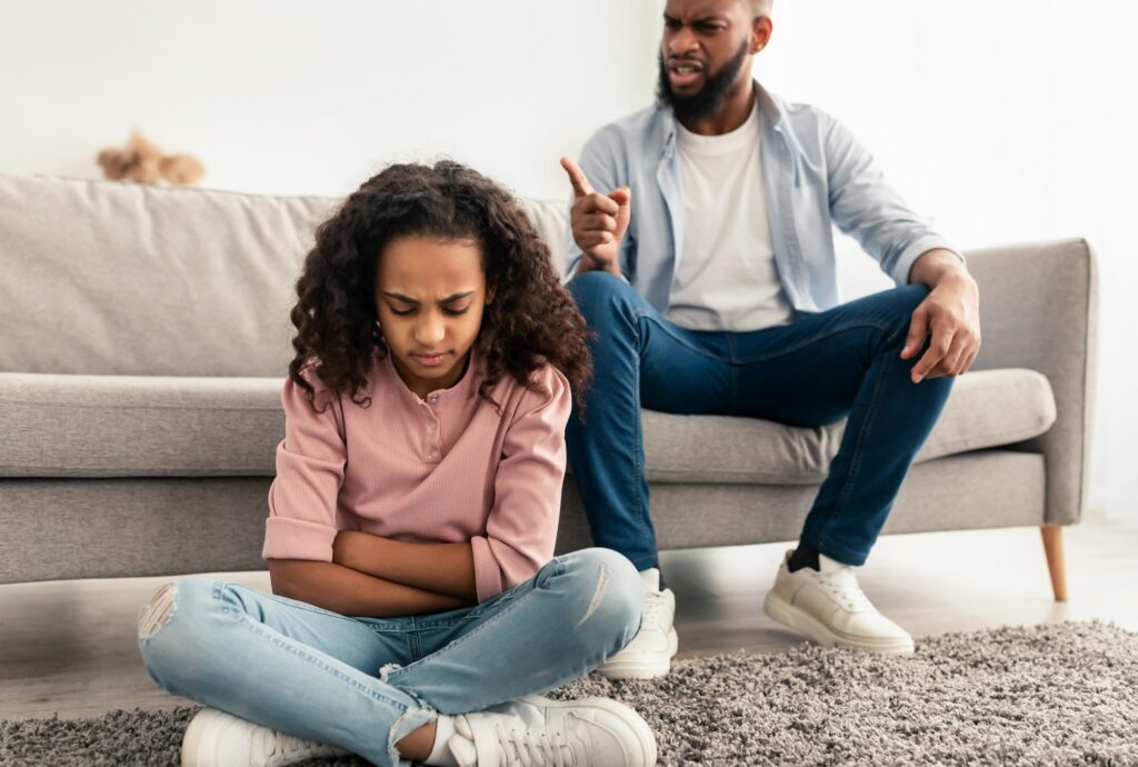 Family Conflict. Angry black father scolding sad daughter